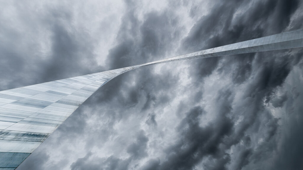 The Gateway Arch in St. Louis, MO with dramatic, threatening clouds